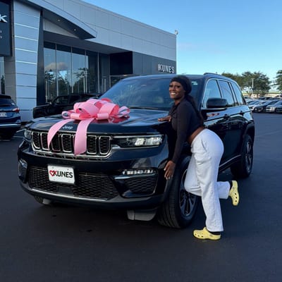 Customer smiling at her new car delivery