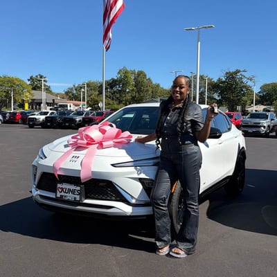 Customer with her new car and pink bow